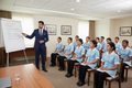 Housekeeping manager training a team of chambermaids and cleaners in a training room